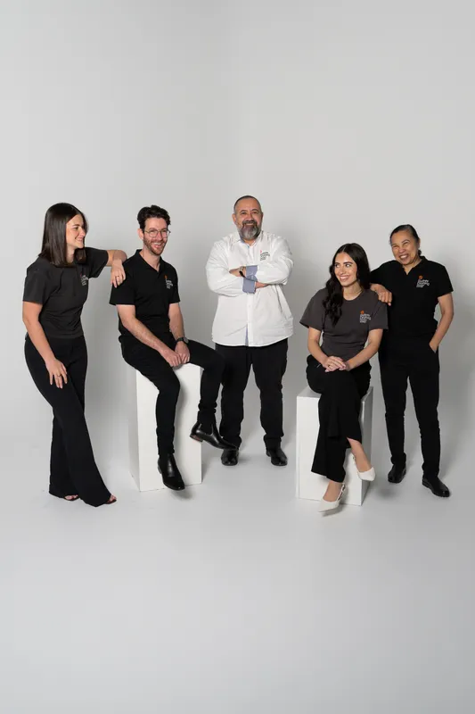 Team portrait of the five staff of Sydney Drafting Concepts & Design in black and white on a white studio backdrop