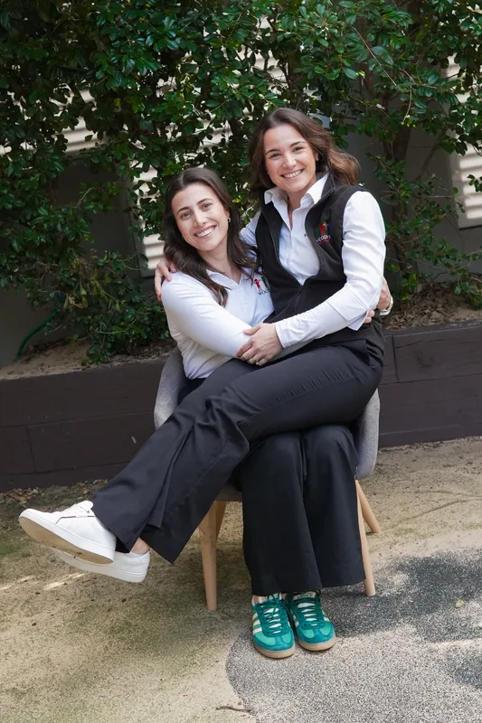 Two Woodstock Early Learning Centre leaders sitting together in the garden