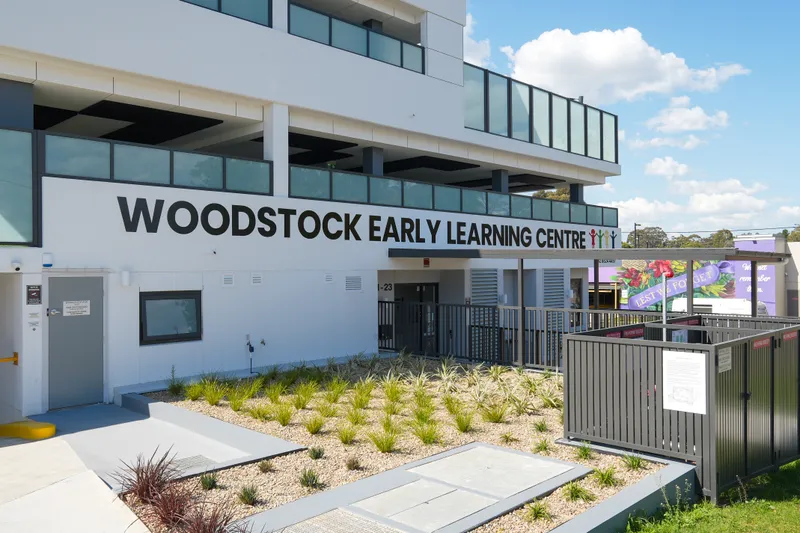 Outside of Woodstock Early Learning Centre with its name on the building and a landscaped garden