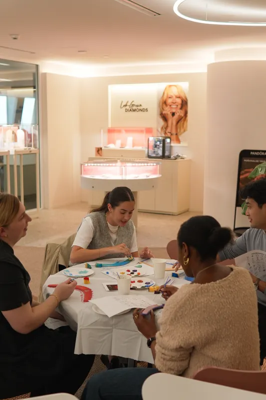 Parents and staff chatting at a table in the bright Woodstock Early Learning Centre reception