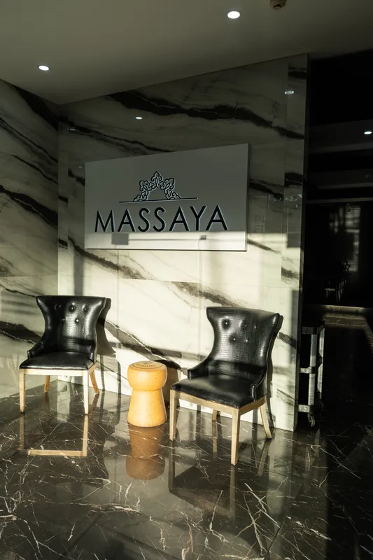 Entrance of Massaya Authentic Lebanese Cuisine with its sign and two black chairs