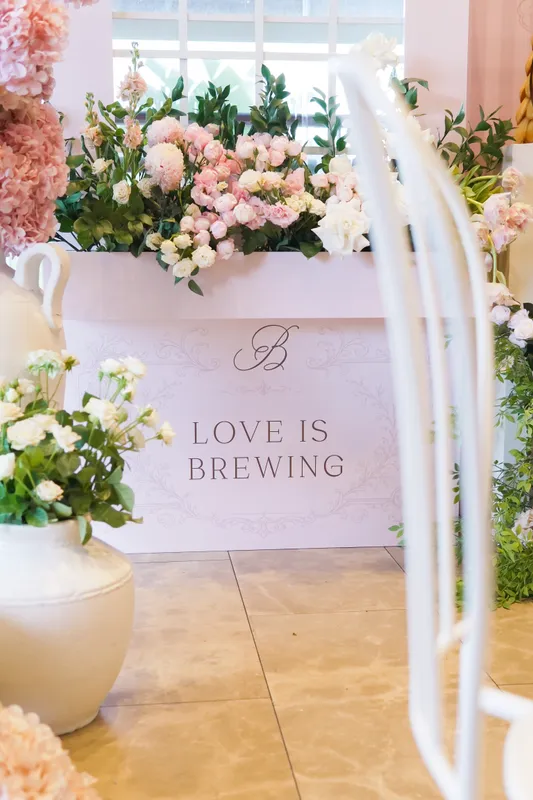 “Love is brewing” bridal shower styling with white flowers and a monogrammed bar