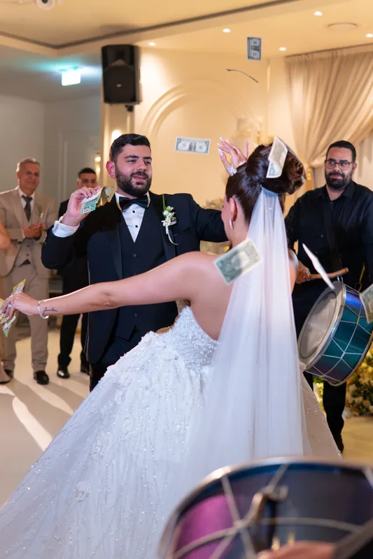 Groom and bride dancing into the reception hall to drums
